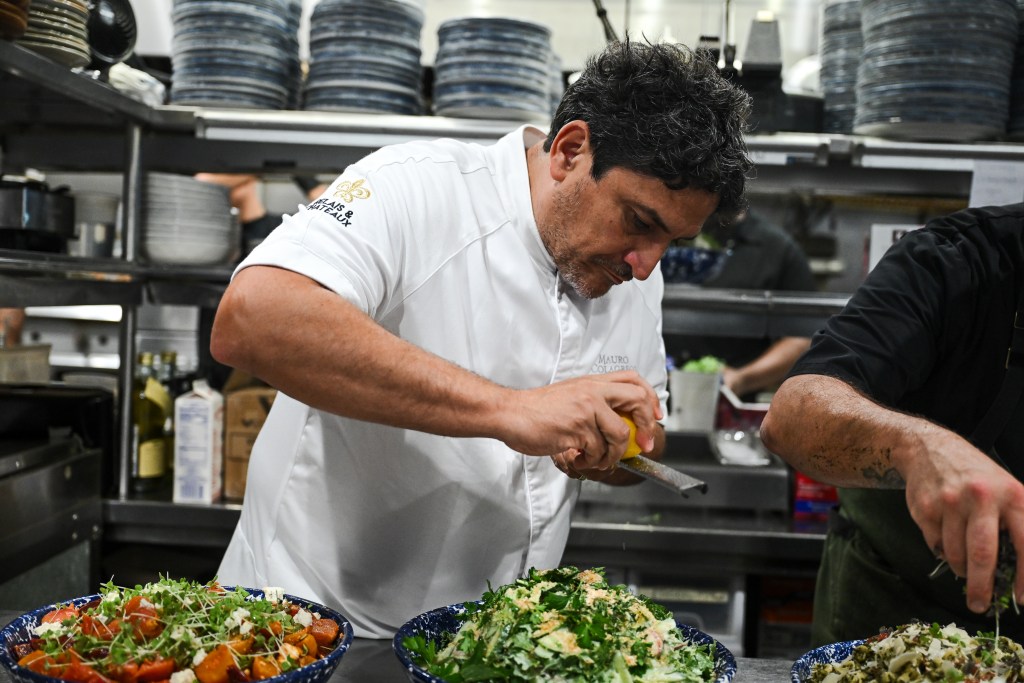 Chef Mauro Colagreco prepping salad dishes in the kitchen.