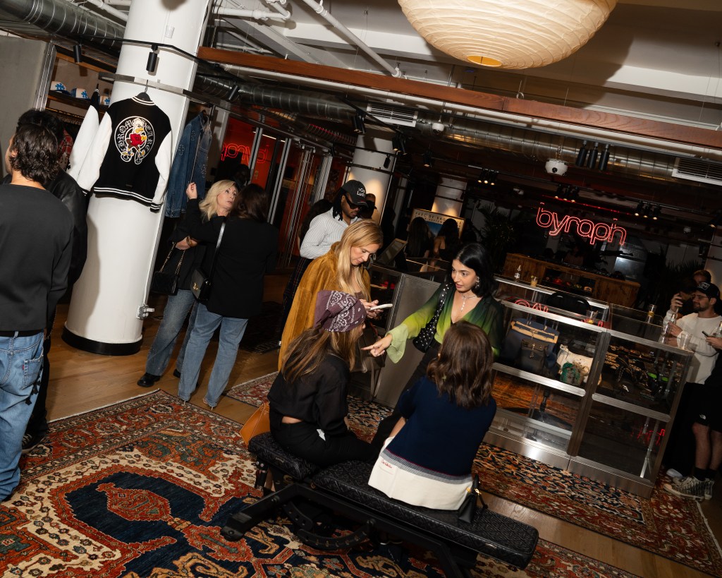 Small groups of people gathered around the large Byraph showroom space.