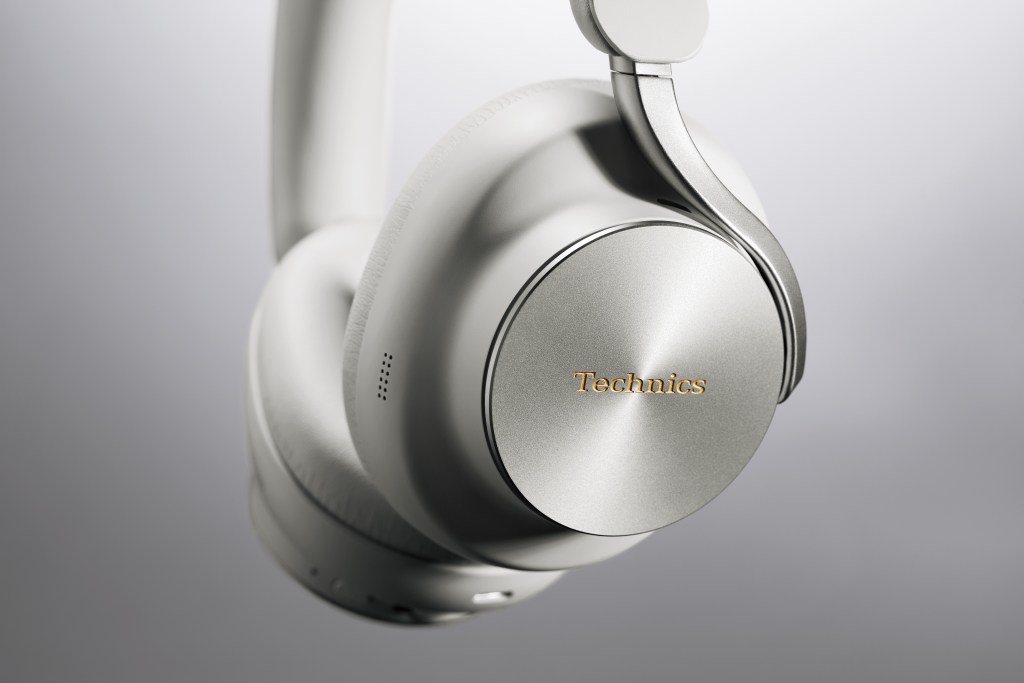 A detail of a pair of Technics with silver details on a gray background.