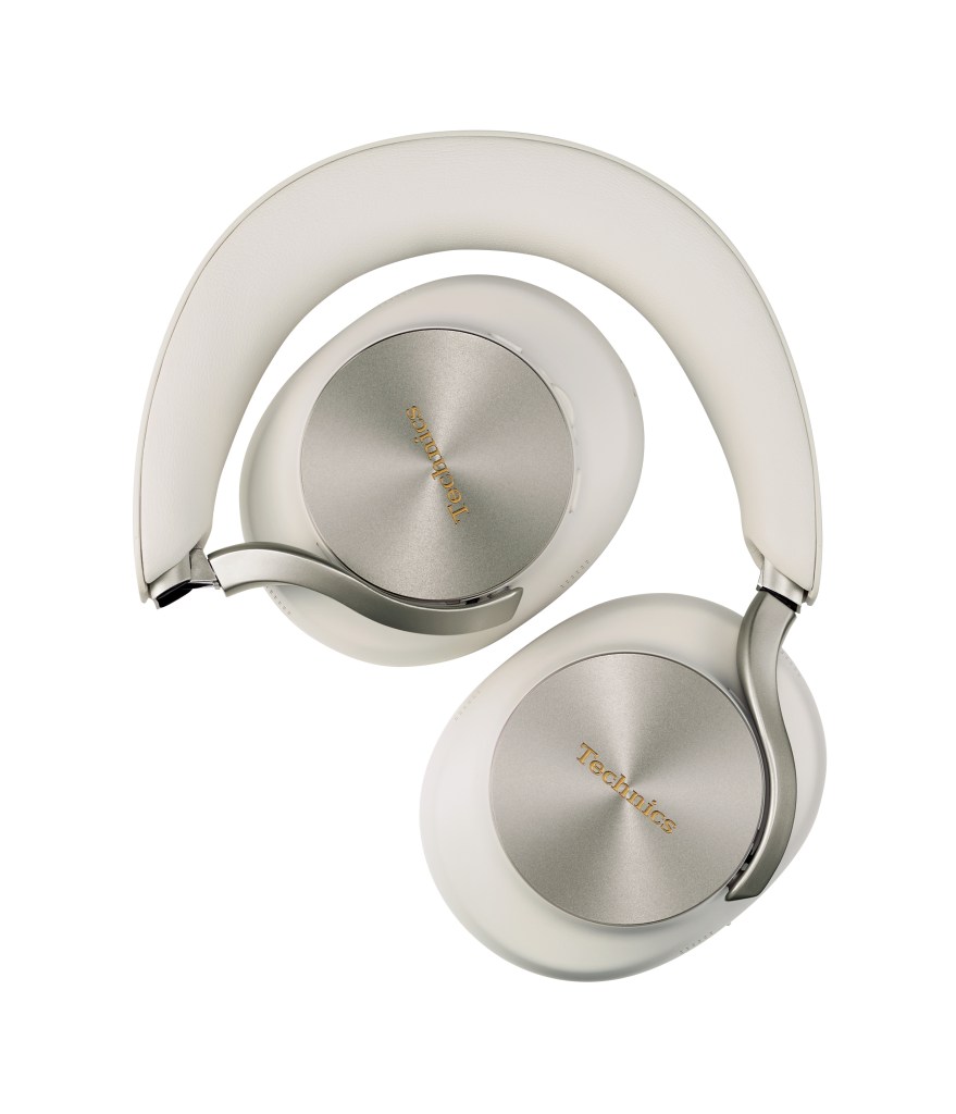 An overhead shot of a pair of light gray Technics headphones with the earcups folded down on a white background.