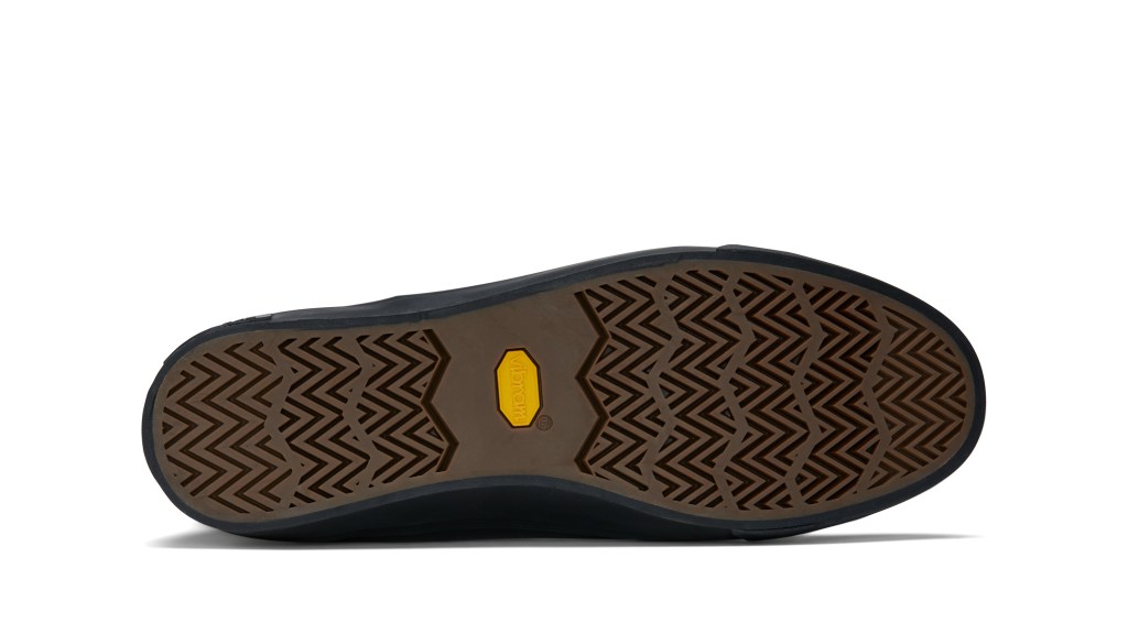 The sole of a pair of Beyond and Back boots with a yellow Vibram logo in the middle.
