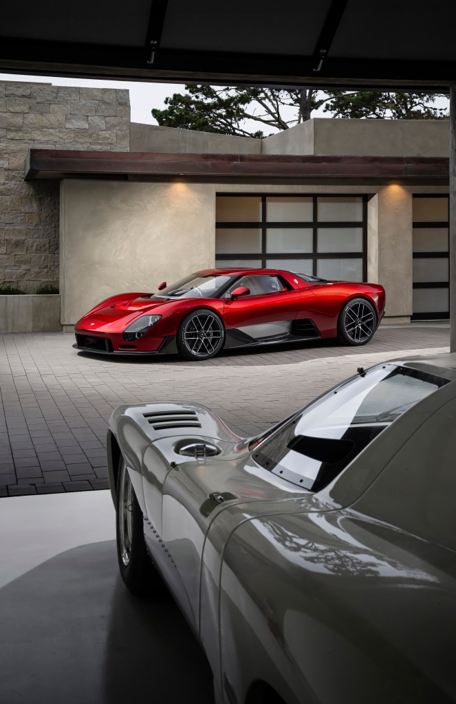 A view of a red McLaren McL 6GT shot from behind a white McLaren car.