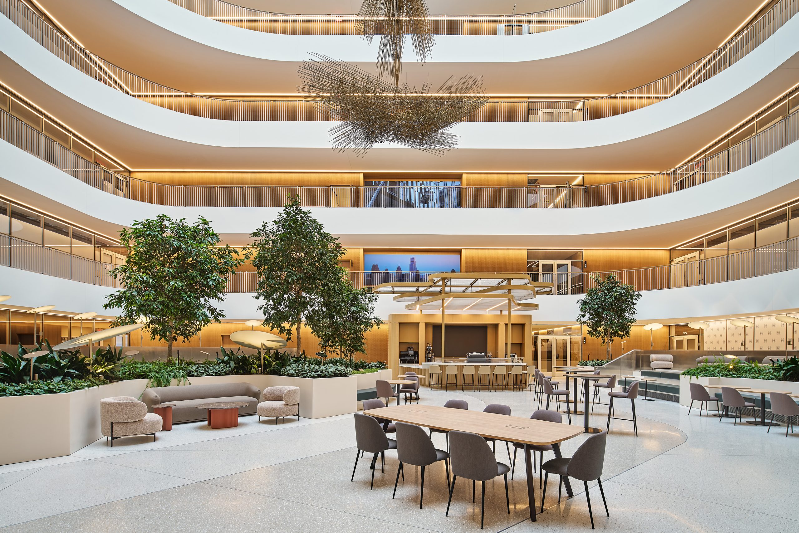 The interior atrium at Hudsons Detroit with communal seating options and a large Bertoia sculpture hanging from the ceiling.