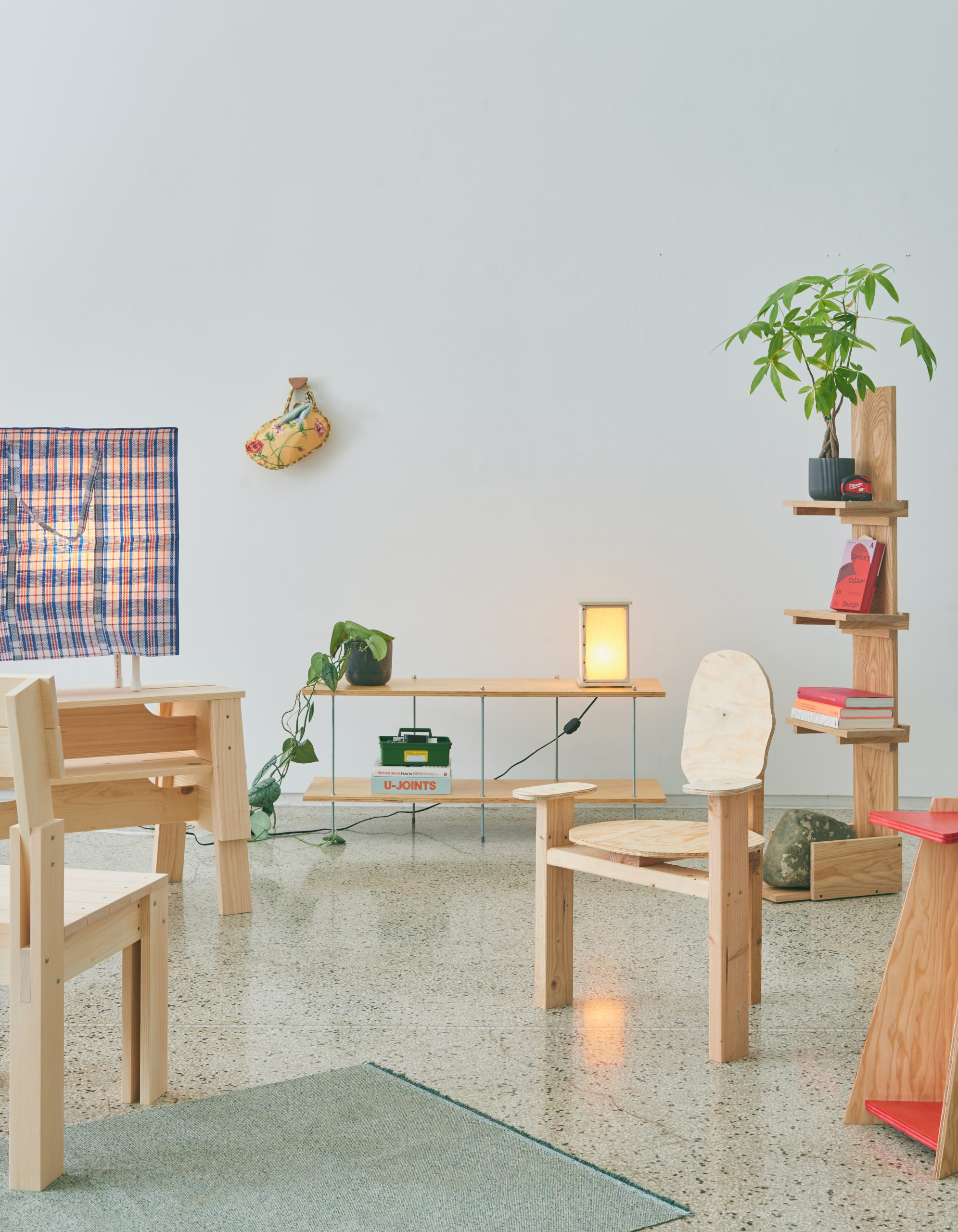 A collection of light wood furniture in a spacious gallery room.