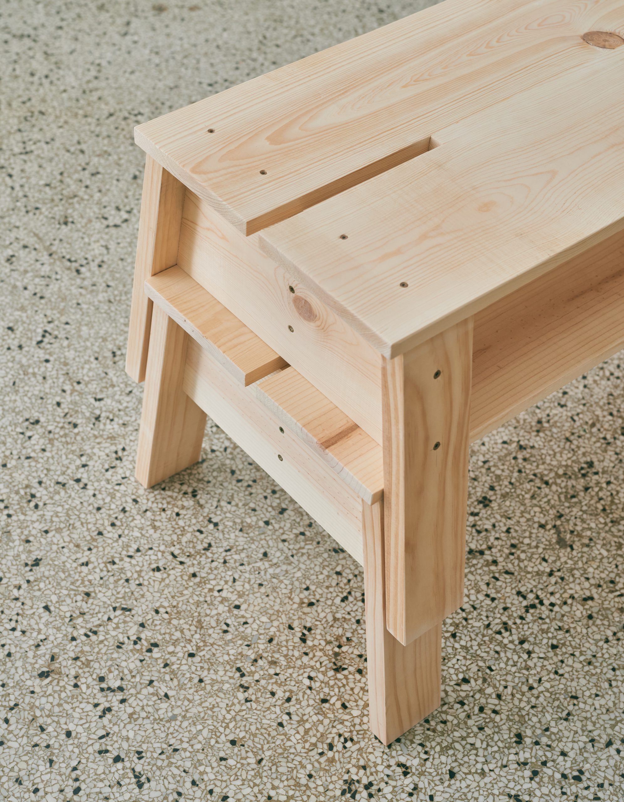 A detail of two wooden benches stacked on top of each other.
