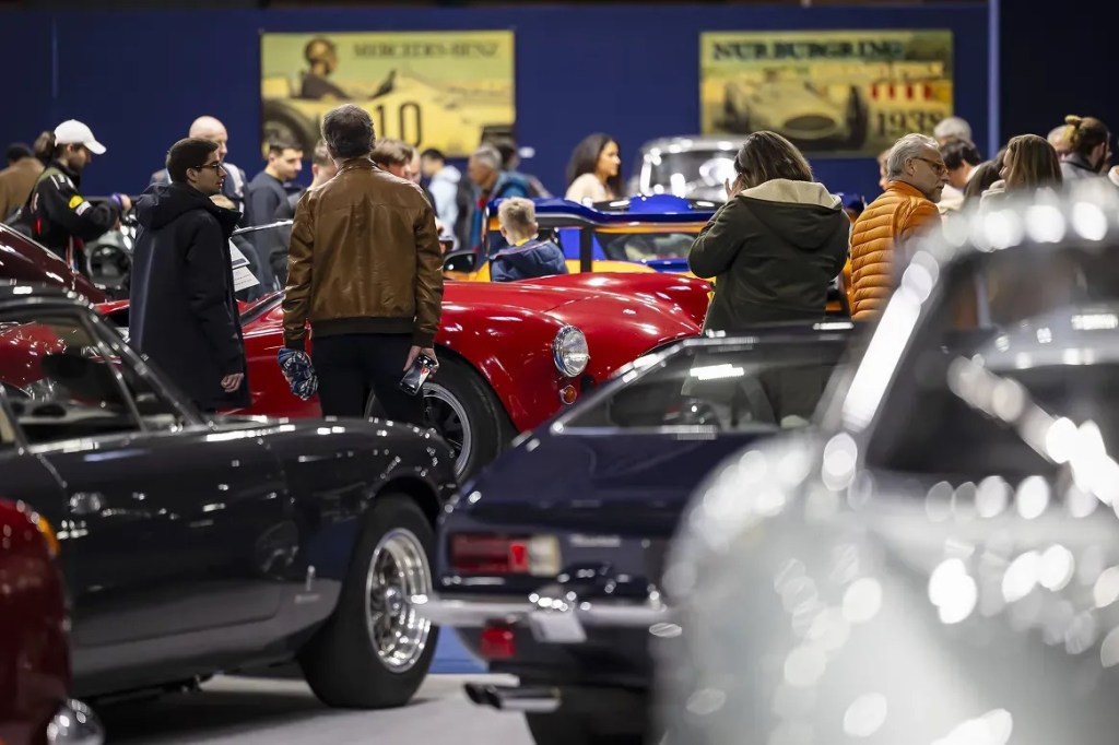 People looking at vintage cars at Rétromobile 2025