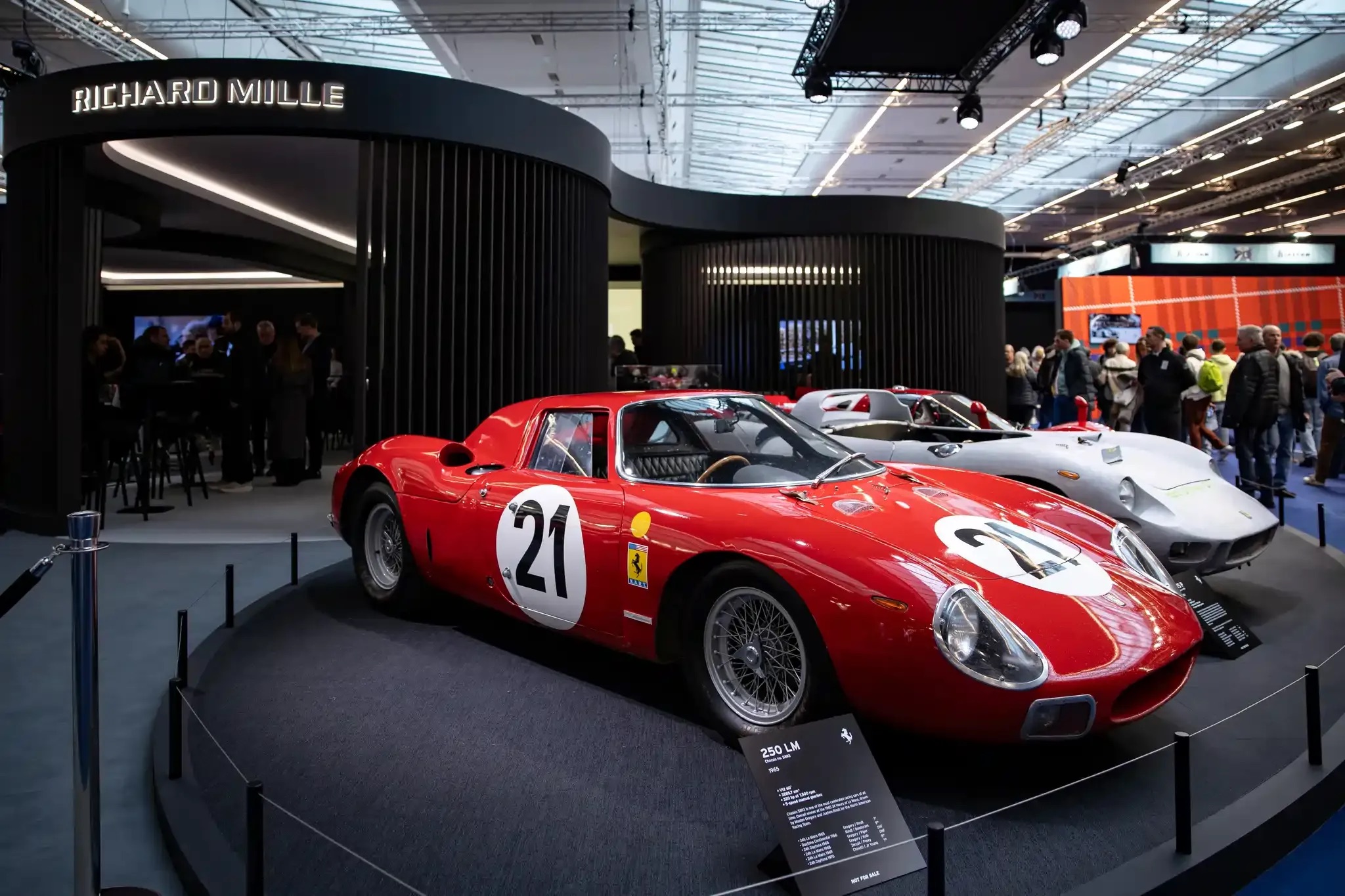 People looking at vintage cars at Rétromobile 2025