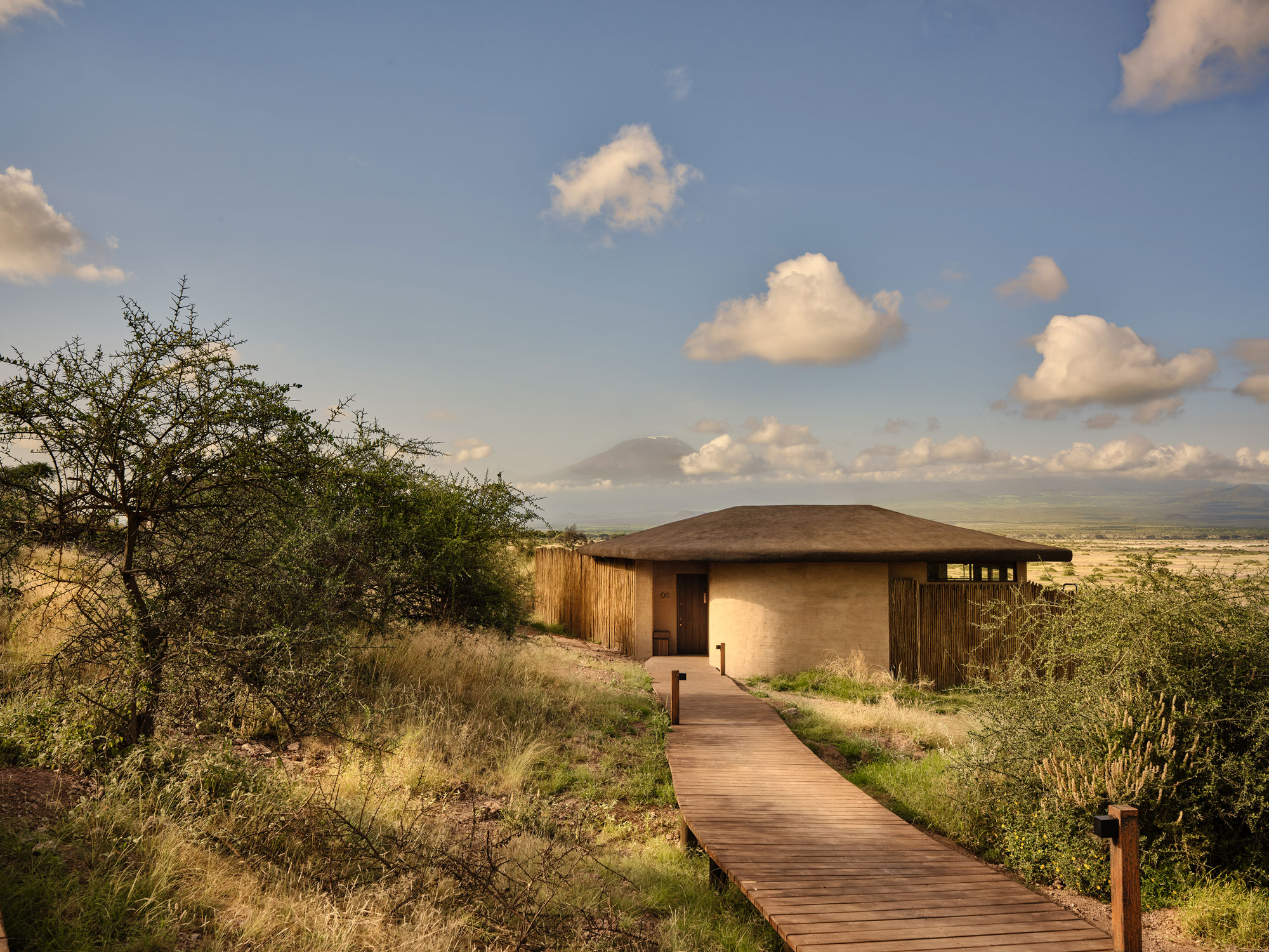 A wooden pathway leading to a guest suite at Kitirua Plains Lodge.