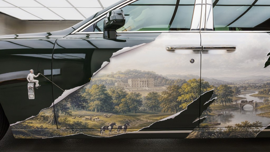 A detail of a Rolls Royce art car by KOZO, showing a hotel employee pulling a rope to reveal an idyllic British landscape. 