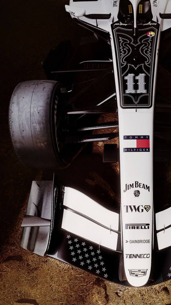 An overhead shot of a Cadillac Formula 1 racecar with several logos on top of it.