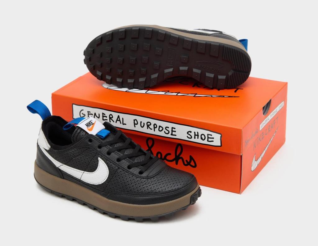 A pair of black and white Nike sneakers, styled next to an orange shoe box that stays "General Purpose Shoe" in a handwritten style.