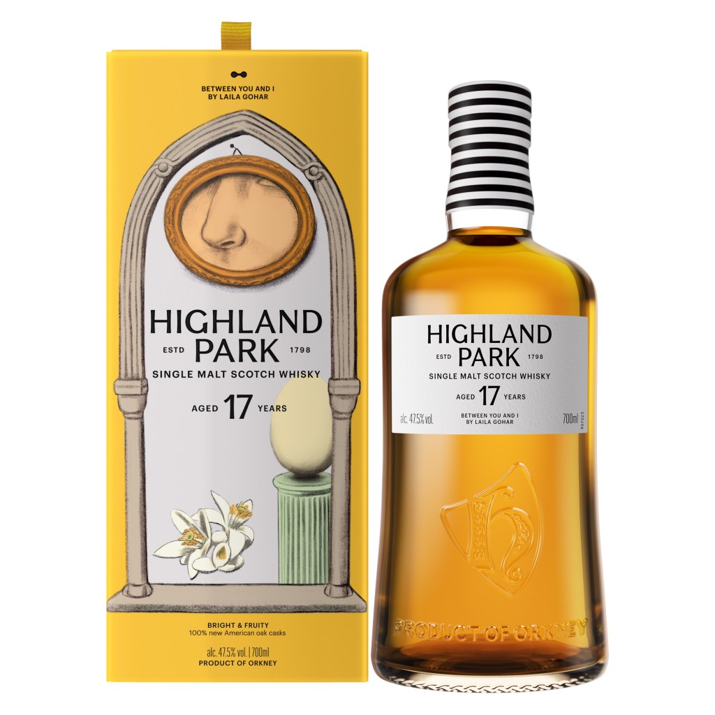 A bottle of Highland Park whisky sitting next to its illustrated yellow box packaging.