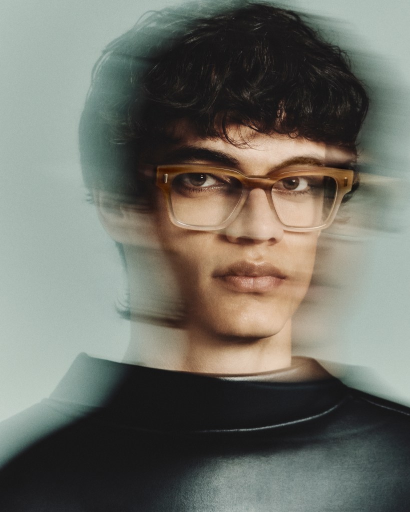 A model with short dark hair wearing a pair of Morgenthal Frederics eyeglasses and looking to the side.