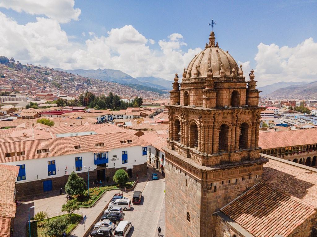 An aerial view of Palacio del Inka hotel surrounded by clay-roofed low buildings.