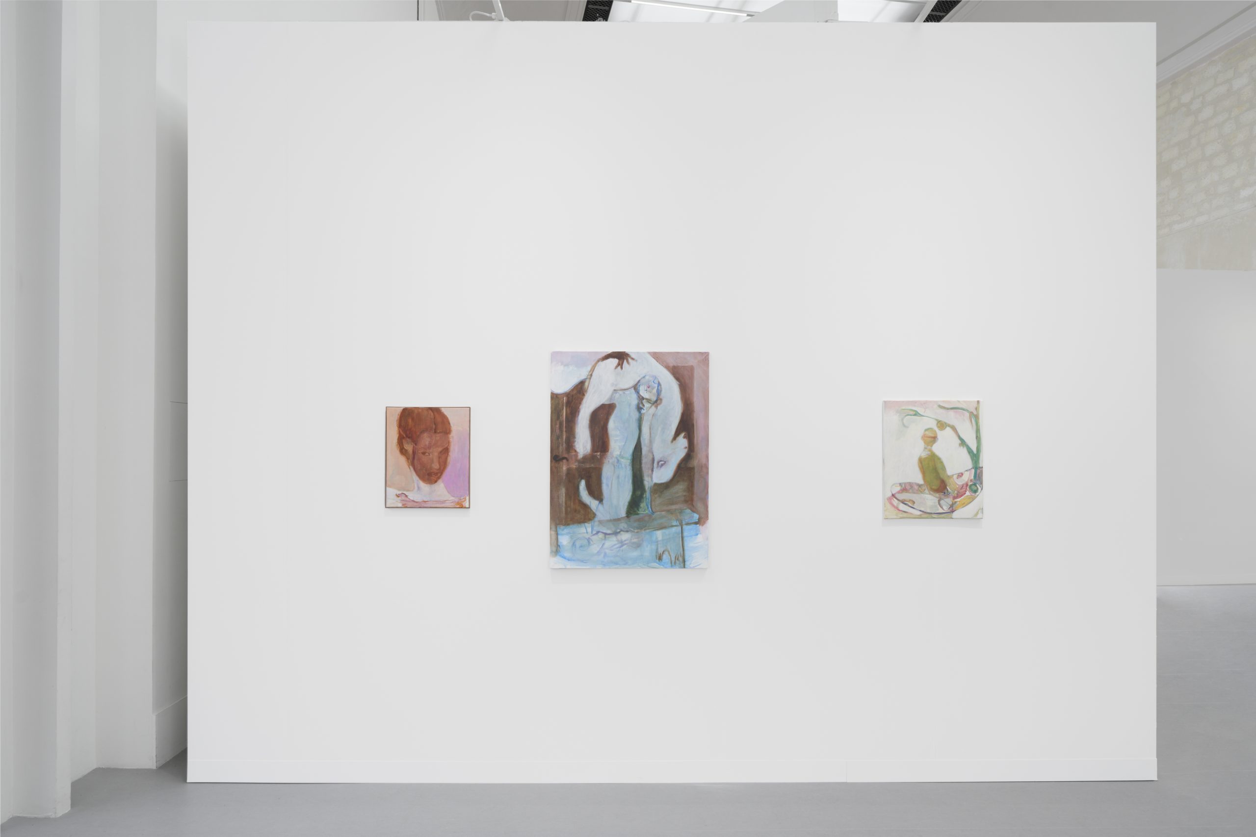 Three paintings by Jessy Razafimandimby hang on a white wall.