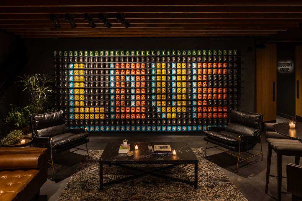 A view of the Industry Lounge at The Truth with a wall of canned goods that spell out "LOVE."