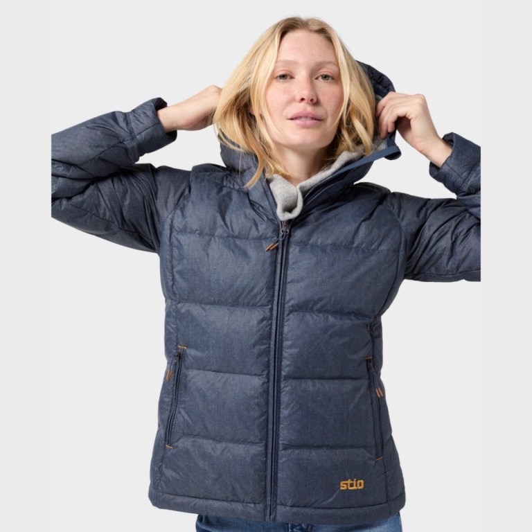 Stio's Womens Hometown Special Edition down jacket in denim worn on a model